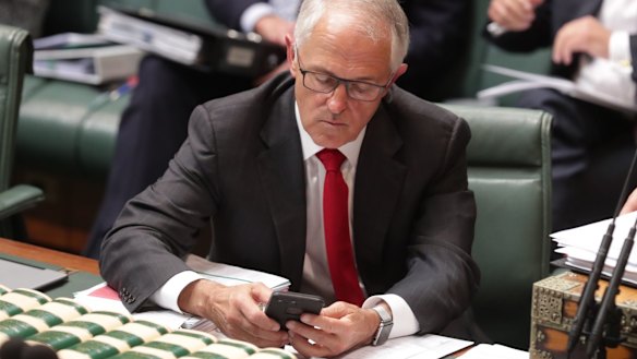 Former prime minister Malcolm Turnbull on his mobile phone.