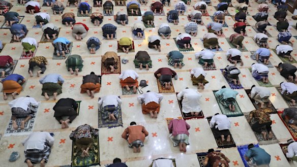 Indonesian Muslims practice social distancing while praying last month.