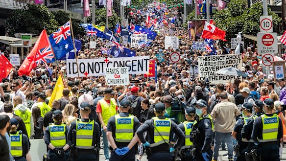 Police look on as protesters gather in Melbourne's CBD.