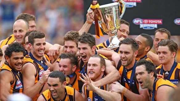A happy team at Hawthorn after completing the rare three-peat against West Coast in 2015.