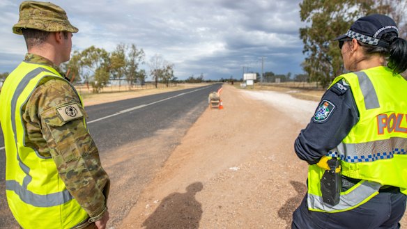 A soldier and police officer patrol Queensland's border with NSW near Hebel in central-southern Queensland.