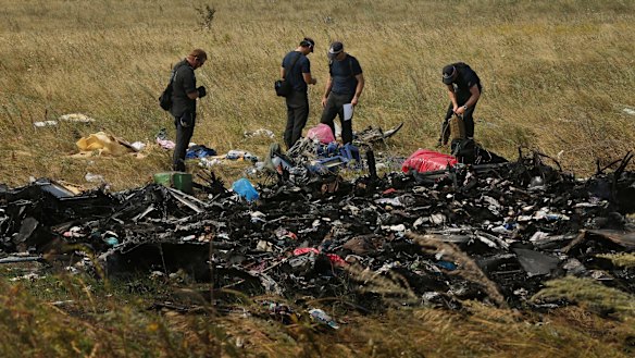 Australian Federal Police officers and their Dutch counterparts search for human remains and personal belongings from the MH17 crash site.