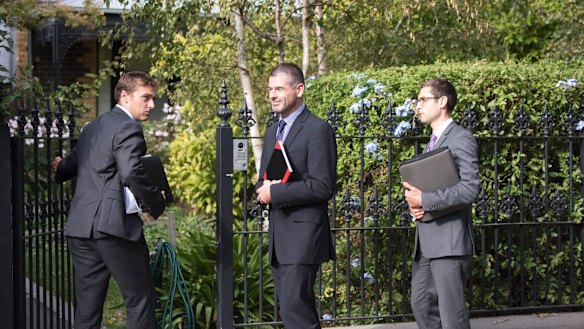 Men believed to be detectives enter the home of Rosemary Rogers, ex-NAB chief of staff, late last year.