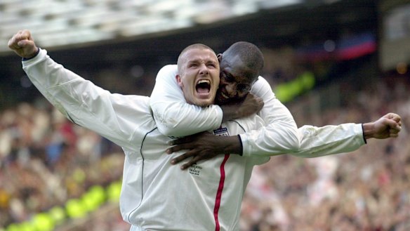 Beckham (with Emile Heskey) after scoring for England against Greece in 2001 in a World Cup qualifier at Old Trafford.
