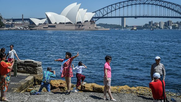 Tourists take in Sydney Harbour at Lady Macquaries Chair.