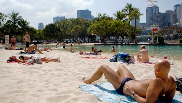 Swimmers and sunbakers enjoy the hot weather at South Bank.