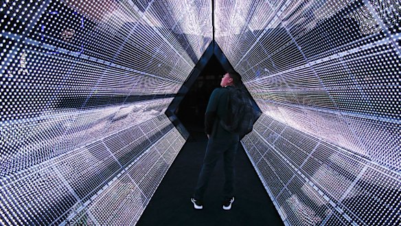 A man stands in the 5G tunnel at the Intel booth at CES International in Las Vegas