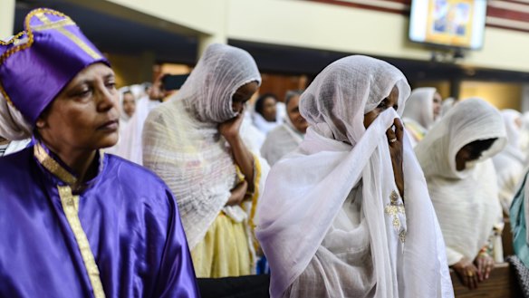 Members of the Ethiopian community take part in a special prayer for victims of the crash at the Ethiopian Orthodox Tewahedo Church of Canada Saint Mary Cathedral in Toronto on Sunday.