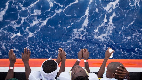 African migrants stand on the deck of the Aquarius.