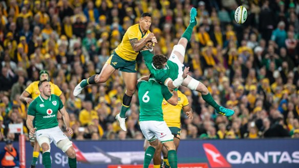 Israel Folau mistimes his attempt at the high ball before getting a yellow card.  