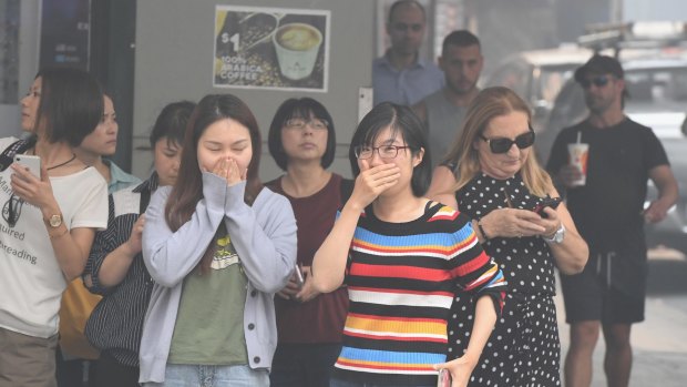 The blanket of smoke makes conditions in Sydney's CBD unpleasant for people during lunch time. 