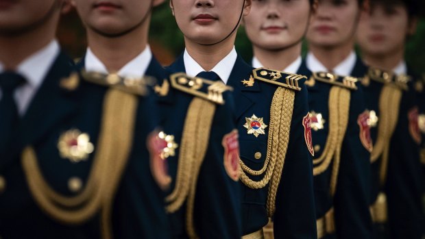 Female members of Chinese People's Liberation Army honour guard wait for the welcome ceremony for Botswana President Mokgweetsi Masisi in Beijing.
