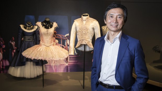 Dancer Li Cunxin poses with works from the exhibition Mao’s Last Dancer the Exhibition: A portrait of Li Cunxin at City Hall.