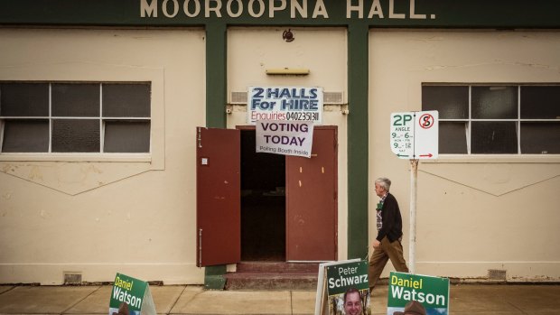 A local constituent prepares to vote at the Mooroopna Hall.
