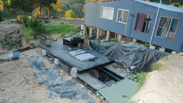 A trapdoor at the Elands property led to three buried shipping containers where a large hydroponic cannabis set-up was discovered and a boy was found locked in a shed.