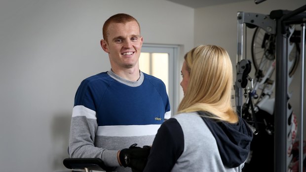 Long road: Knights physio Pip Cave helps Alex McKinnon with his rehabilitation last year.