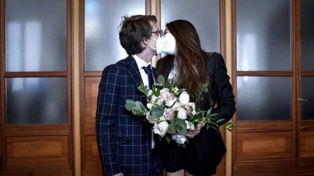 A just married couple kiss in the registry offices after the civil ceremony in Milan.