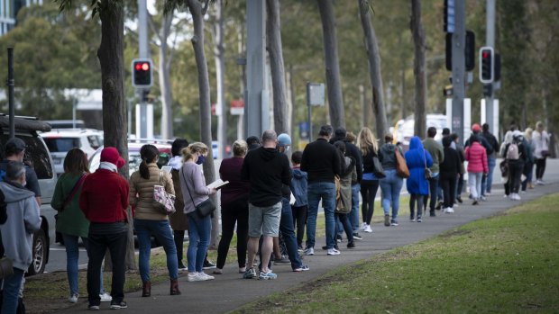 People wait in line at the mass vaccination centre at Sydney’s Olympic Park this week. 