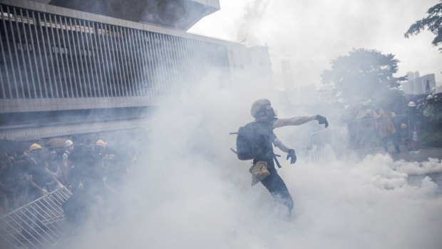 A protester obscured by clouds of tear gas in Hong Kong on Wednesday. 