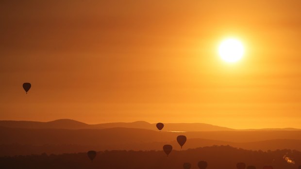 Hot air balloons during sunrise over Canberra in March 2018.