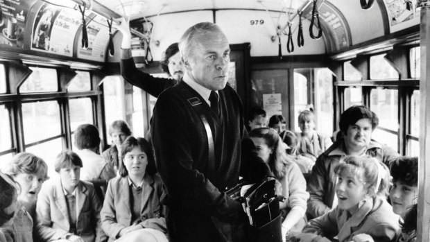 A Melbourne tram, circa 1985: Conductor Jimmy Fitzgerald collects fares.