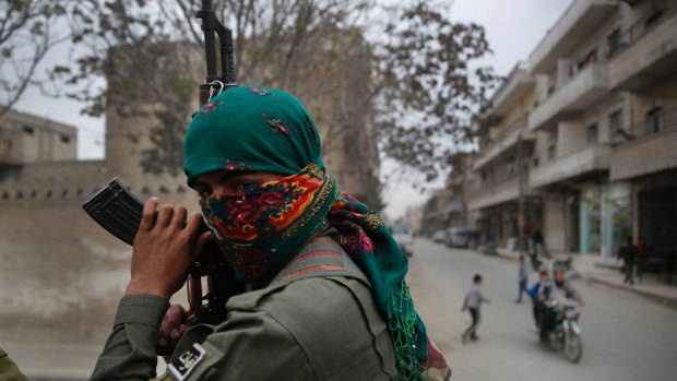 A member of the Kurdish internal security forces holds his weapon during a patrol in Manbij, north Syria, earlier this year.