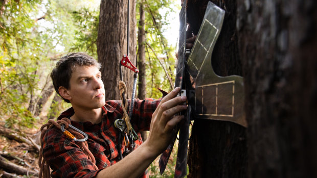 Topher White, chief executive of Rainforest Connection, attaches a modified smart phone powered by solar energy that will be used to detect illegal logging. 