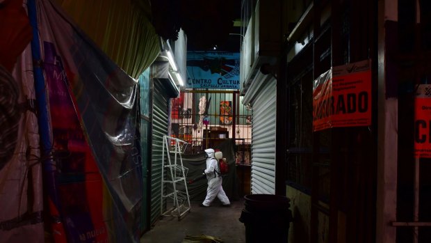 A sanitary team disinfects the Jamaica Market, which is scheduled to reopen today in Mexico City.