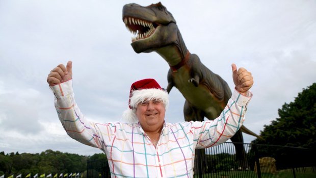 In happier times: Clive Palmer with Jeff the dinosaur which was destroyed by fire.
