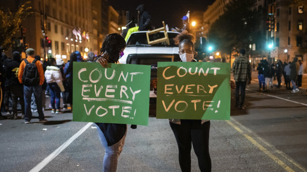 Demonstrators get their message across in Washington as the US waits for a result from the presidential election.