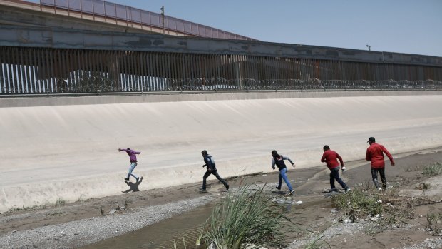 Migrants cross the Rio Bravo illegally to surrender to the American authorities, on the US - Mexico border between Ciudad Juarez and El Paso.