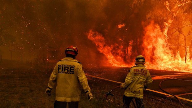 Fire and Rescue workers battling the Gospers Mountain blaze in Berambing as it crosses the Bells Line of Road.