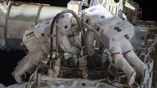 Scott Kelly (at left) on a space walk outside the International Space Station. 