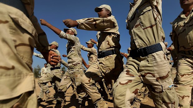 Iraq army recruits march during training at Camp Taji in Iraq. Australia has contributed resources to train Iraqis and help stem the influence of Islamic State as part of the coalition.