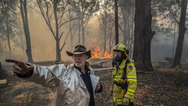 Taree South resident Carl Silver with Firefighter Adam Brown.