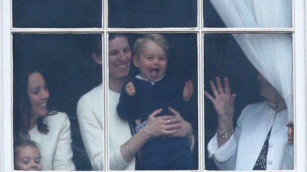 An excited Prince George, held by his nanny Maria Borrallo watches the Queen’s birthday parade in 2017.