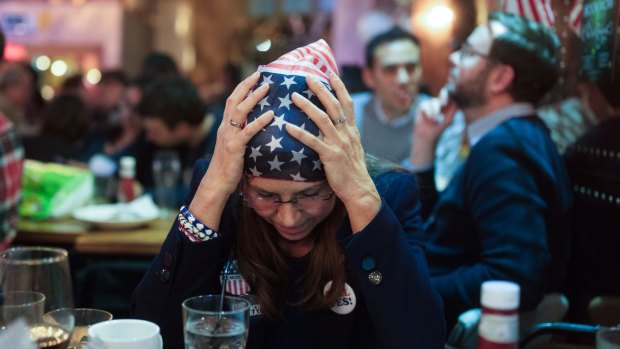 A Democratic Party supporter watches 2016 election results come in. 