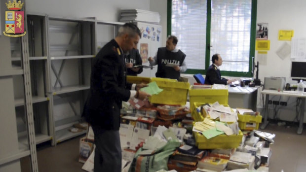 Italian postal police officers sort undelivered mail found in a postman's garage, in Vicenza, northern Italy, before the 2010 elections.