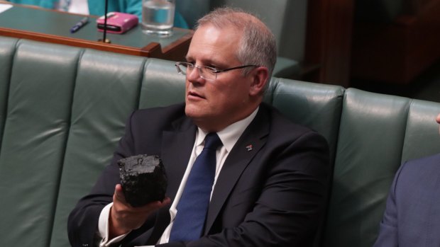 Prime Minister Scott Morrison with a lump of coal during Question Time at Parliament House in 2017. 