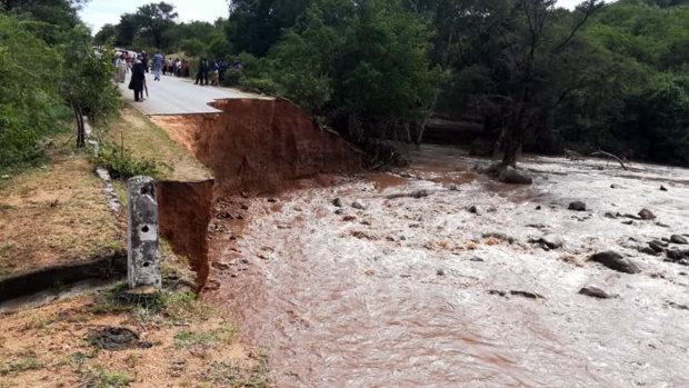 Locals in Chimanimani, Zimbabwe, look at a damaged bridge in the aftermath of Cyclone Idai. 