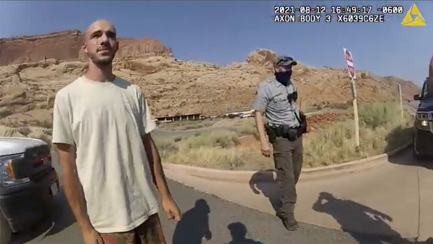 A police camera video still shows Brian Laundrie talking to a police officer on August 12.