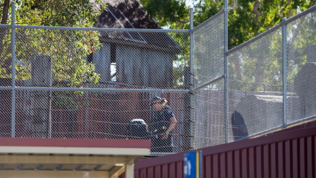 Police examine the scene at Dreamworld where four people died.