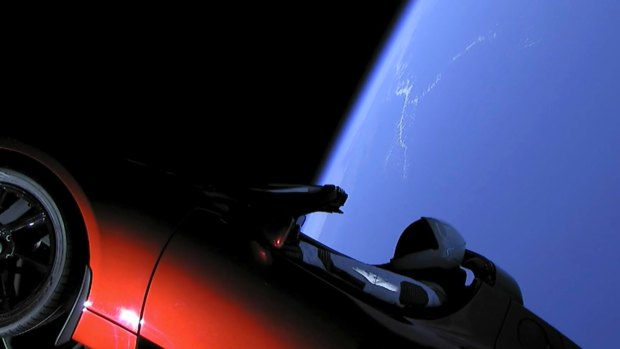 This image from video provided by SpaceX shows the company's spacesuit in Elon Musk's red Tesla sports car which was launched into space during the first test flight of the Falcon Heavy rocket.