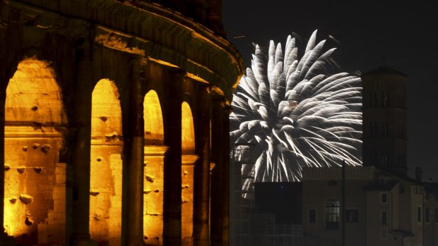 Fireworks explode in the sky next to Rome's Colosseum during New Year's celebrations, in Rome.