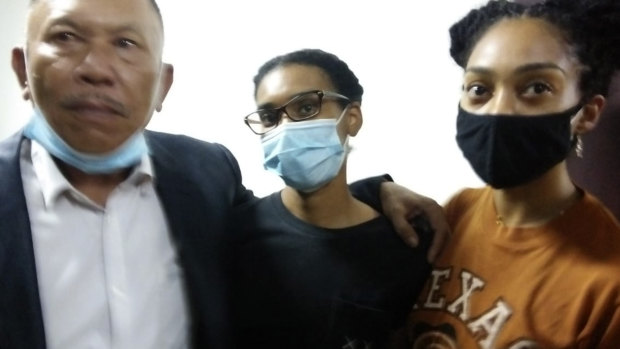 Kristen Antoinette Gray, centre, her partner Saundra Michelle Alexander, right, and lawyer Erwin Siregar arrive at the immigration office for questioning, in Denpasar, Bali, on Tuesday.