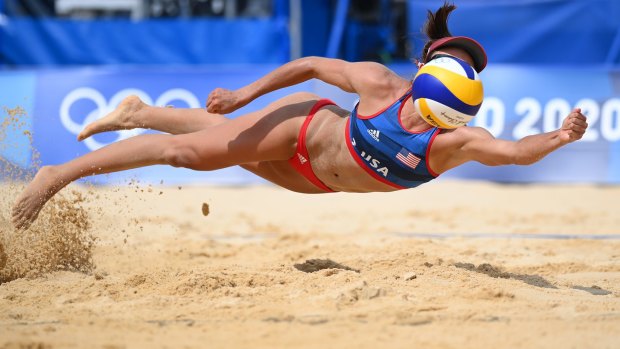USA’s Sarah Sponcil #2 dives to return the ball against Latvia at the beach volleyball preliminaries on Monday.