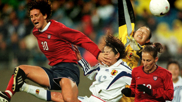 US champion Michelle Akers  (far left) heading the ball into goal in 1999.