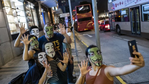 Demonstrators wearing face masks pose for a selfie during the Face Mask Way event in Hong Kong.