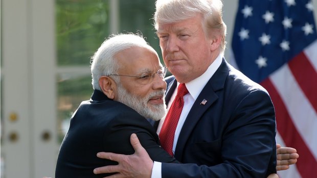 President Trump and Indian Prime Minister Narendra Modi hug outside the White House.