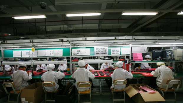 Workers are seen inside a Foxconn factory in the township of Longhua in the southern Guangdong province. 